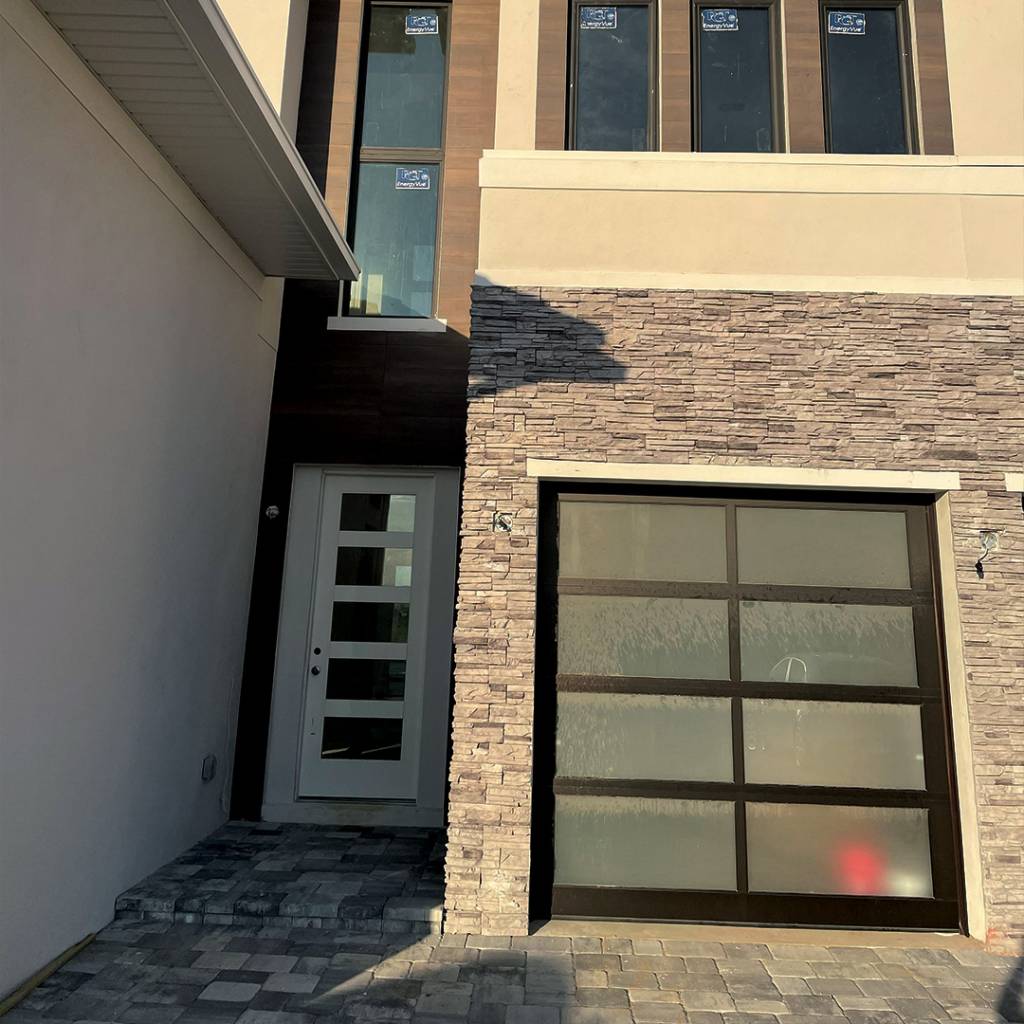 The front of the house covered in stone.