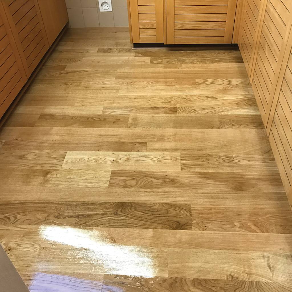 A kitchen floor renovated with wooden flooring.